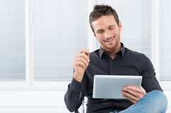 http://www.dreamstime.com/stock-photo-young-man-using-digital-tablet-portrait-handsome-happy-image30882410